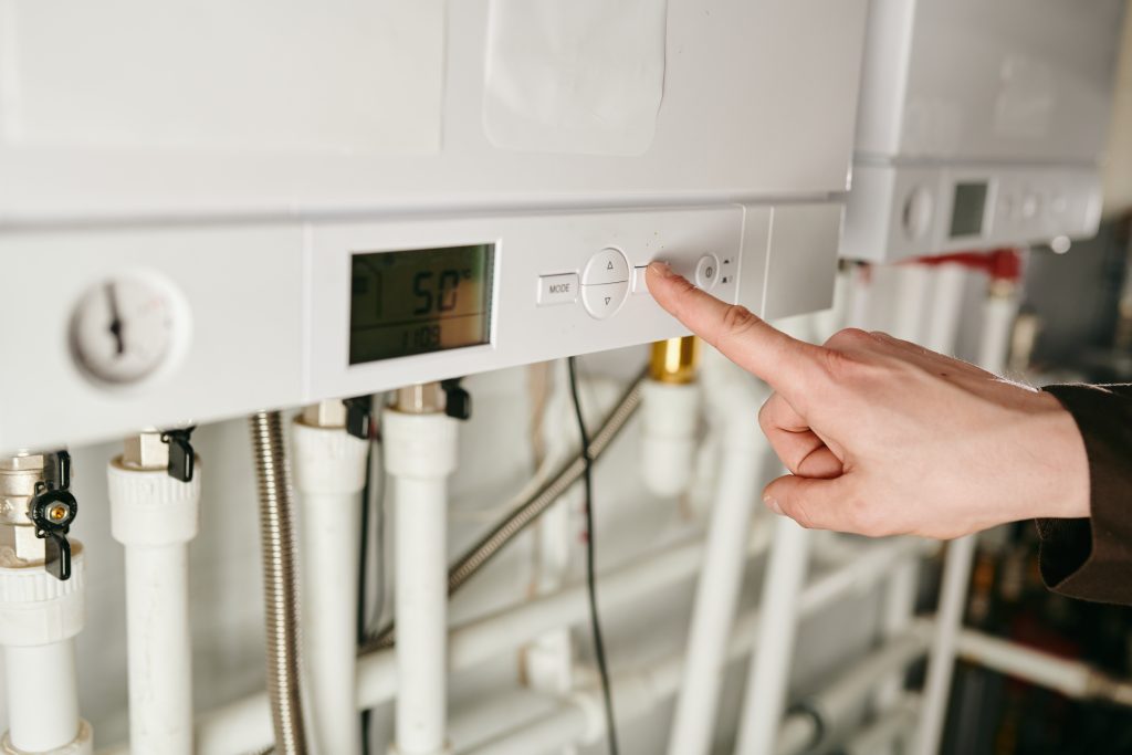 A hand of technician pressing button of air conditioner