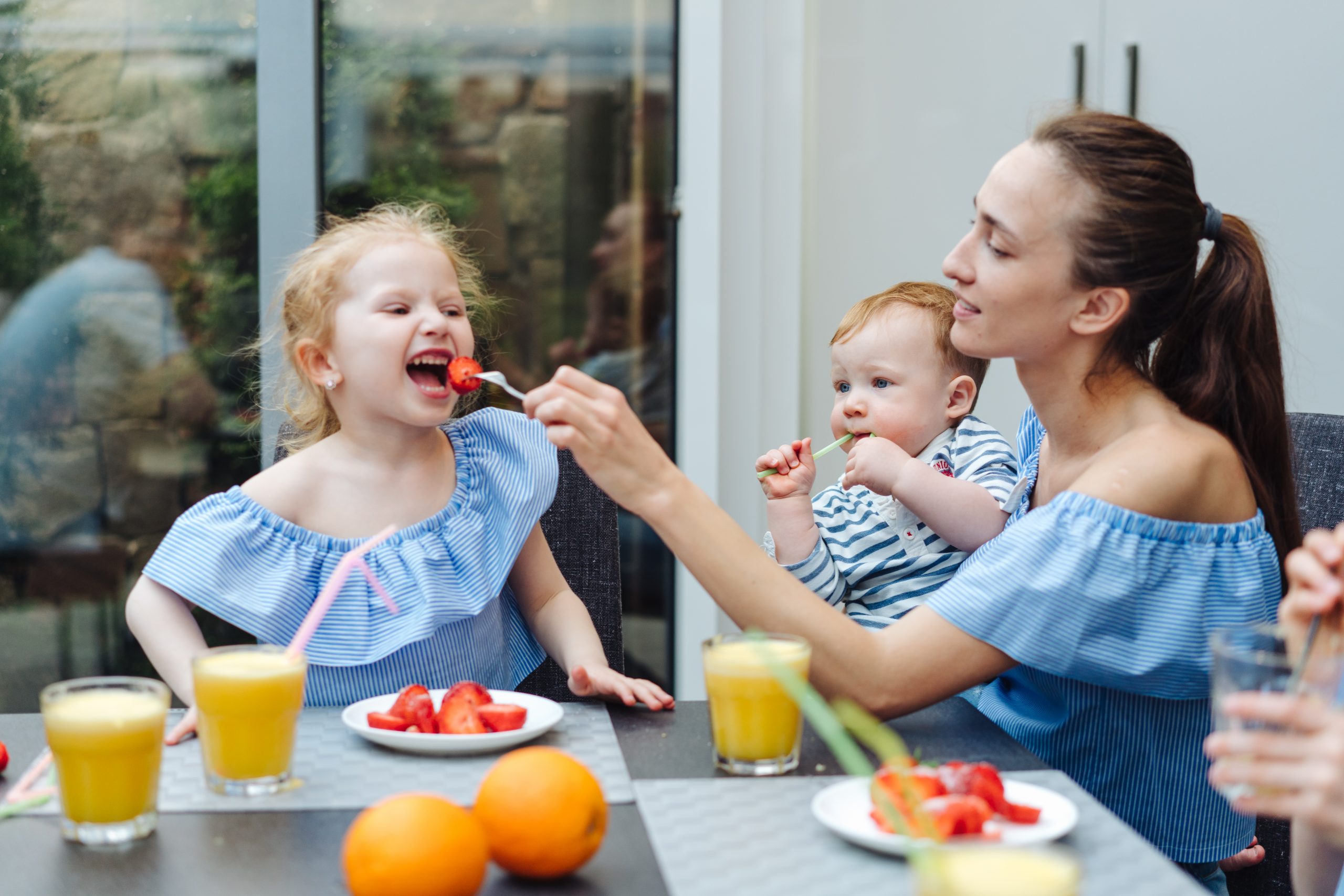 Happy family, fresh fruit breakfast in kitchen