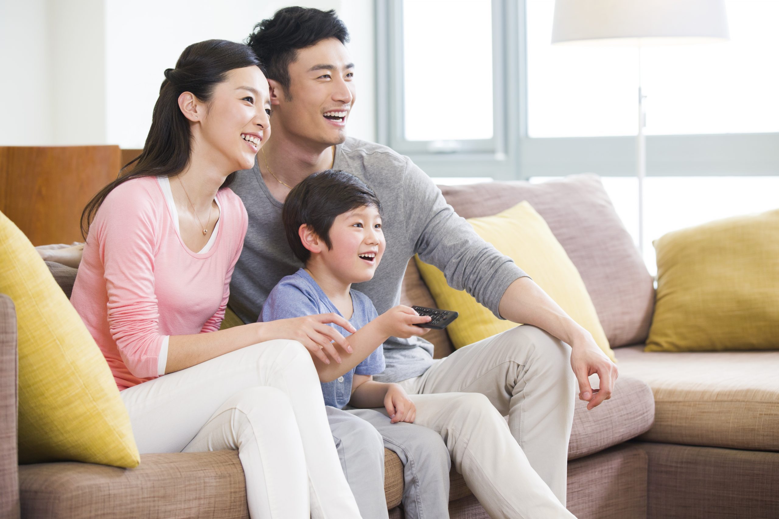 Happy Chinese family watching TV